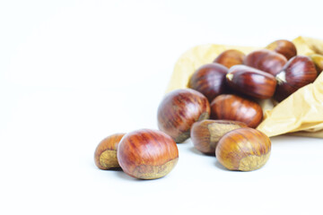 Chestnuts on a white background and paper bag,	