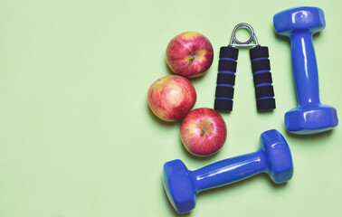 Physical activity and good nutrition lifestyle concept, represented with sports and fruit accessories. Zenith view and copy space.