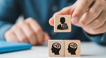 Hand selecting a person icon from blocks with gears representing mind