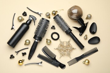 Hairdresser's tools and Christmas decor on beige background, flat lay