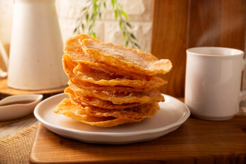 Mexican Buñuelos. Traditional food at Christmas and winter holidays in Mexico, these are fried dough flatbread sprinkled with sugar or covered in a syrup made with piloncillo, cinnamon, and guava.