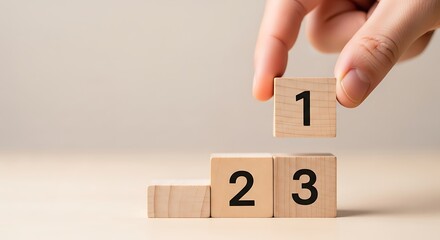 Hand placing a wooden block with number 1 on podium
