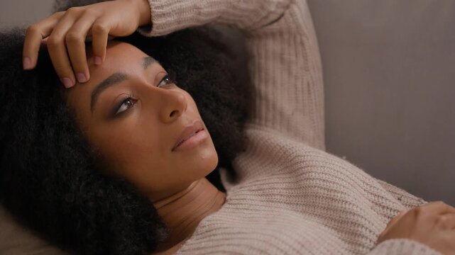 Pensive thinking problem solution sad African American woman lying on sofa girl frustrated hesitate worried stress depress on couch female suffering from negative thoughts headache unwanted pregnancy