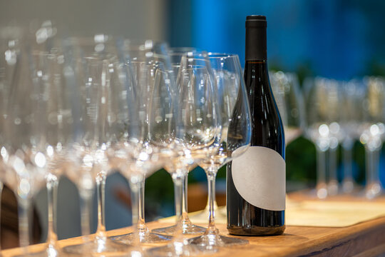 Red wine bottle and empty glasses preparing for tasting