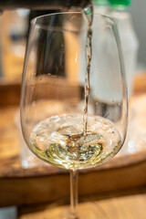 White wine pouring into glass, celebrating moments
