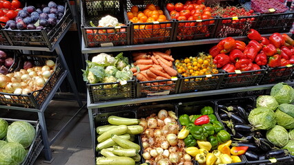 A variety of vegetables and fruits lying on a market counter for sale by a customer. Trade in agricultural products. Nitrates and pesticides. Genetically modified food. Farm fruits. Fiber and vitamins