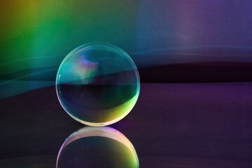 Prismatic Sphere Reflection. Glass sphere with rainbow hues reflecting light on a smooth surface.