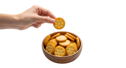 Hand picking round cracker from wooden bowl against black background biscuit snack