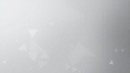 A blurry gray background with a few white circles. The background is mostly gray with some white