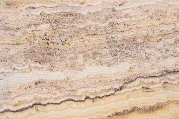 Textured marble surface with natural swirls and earthy tones for backgrounds