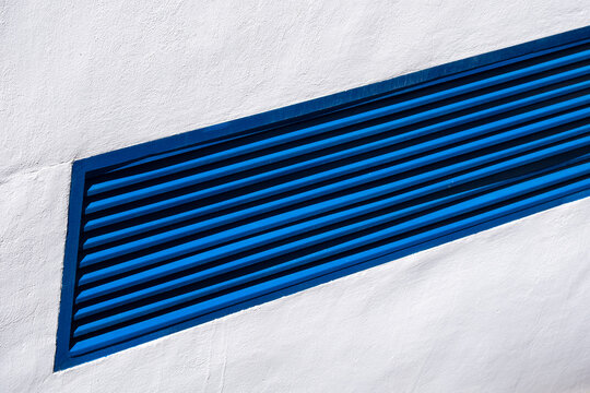 Geometric blue louver on white wall - minimalist architectural design