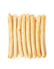 Isolated chew sticks in a row for dogs or cats as treat or reward. Rawhide alternative for dog and cat dental health and enrichment snack. Pile of rolled sticks made of chicken. Selective focus.