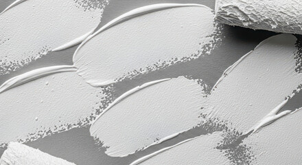 Close up of white texture paint strokes on a grey background