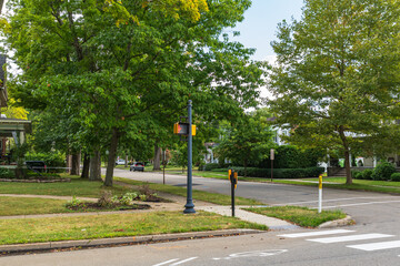 An intersection in a residential area in Warren, Pennsylvania, USA on a sunny summer day
