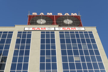 Fototapeta premium Sam the Record Man sign installed atop 277 Victoria St, facing Sankofa Square, Toronto