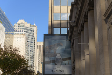 Fototapeta premium view east on Bloor St W near Queens Park/Avenue Rd with banner ad for Cartier watches, Toronto