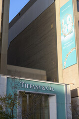 Fototapeta premium exterior wall and long hanging banner and sign over entrance to Tiffany & Co, a jewelry store, located at 150 Bloor St W (inside 89 Avenue Yorkville), Toronto