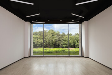 Floor-to-ceiling window with garden view in empty spacious room. Interior design