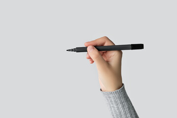 Hand Holding a Black Marker Pen Ready to Write or Draw