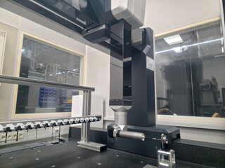 Close up on a Coordinate Measuring Machine using precision tools in an advanced manufacturing workshop