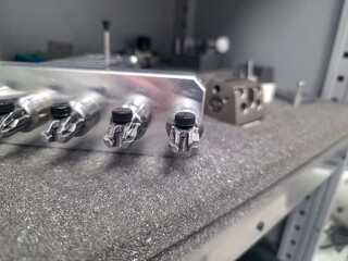 Precision engineering a series of metal components displayed on a textured work surface