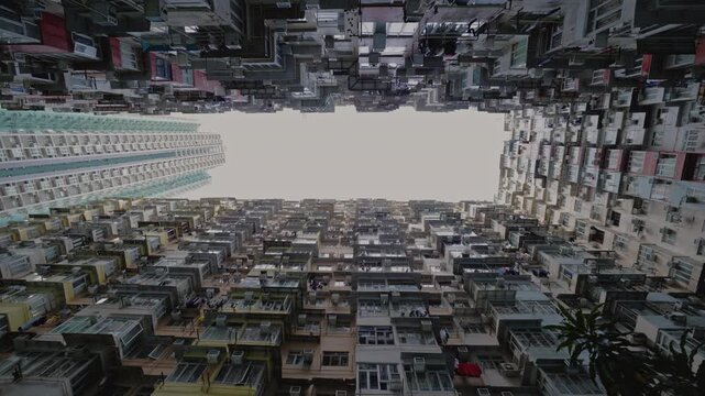 Famous Monster building with small balconies on facade in dwelling block under gloomy sky. Old condominium complex popular among tourists in Asian city. Architecture