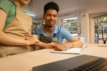 Entrepreneur couple collaborating on small business in workshop