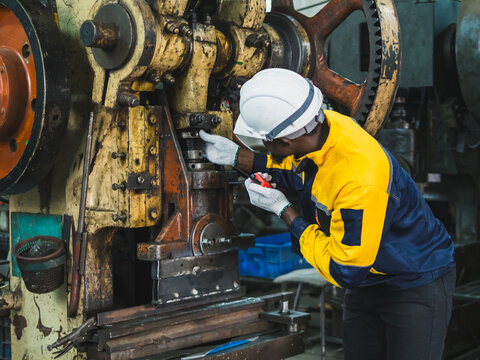 Industrial engineer technician worker man with helmet and uniform safety vest look hand holding radio communication talk look inspection quality control production in manufactory industry technology