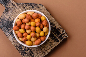 Food, nuts coated with salt and paprika, peanuts as a source of protein. Salted peanuts