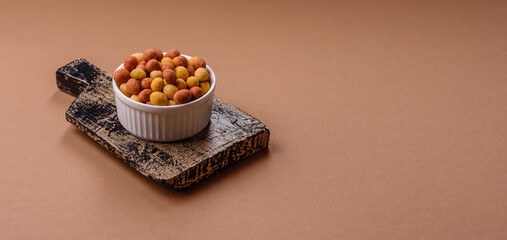 Food, nuts coated with salt and paprika, peanuts as a source of protein. Salted peanuts