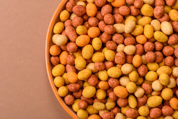 Food, nuts coated with salt and paprika, peanuts as a source of protein. Salted peanuts