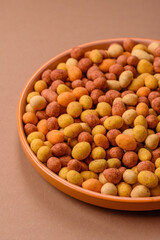 Food, nuts coated with salt and paprika, peanuts as a source of protein. Salted peanuts