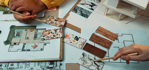 A vibrant workspace showcases hands selecting design samples from a mood board, emphasizing...