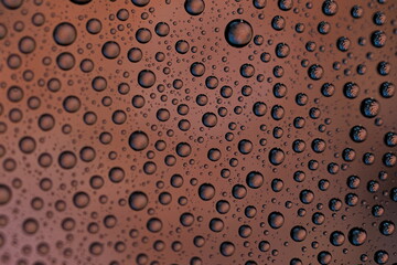 Macro shot of water droplets on blue and green gradient surface