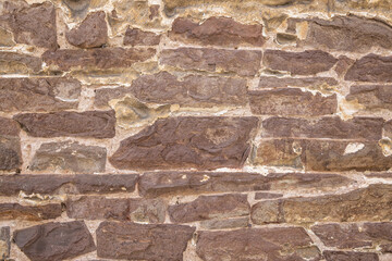 Red stone wall on an old building.