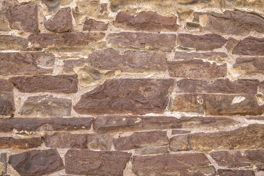 Red stone wall on an old building.