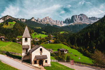 Panoramic view of the St. Cyprian Chapel in Tiers am Rosengarten mountain range in the Dolomites, Italy.