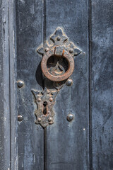 Fototapeta premium Rusted knocker on a black painted door.