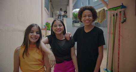 Teenagers laughing and smiling together in a suburban alleyway, enjoying carefree moments,...