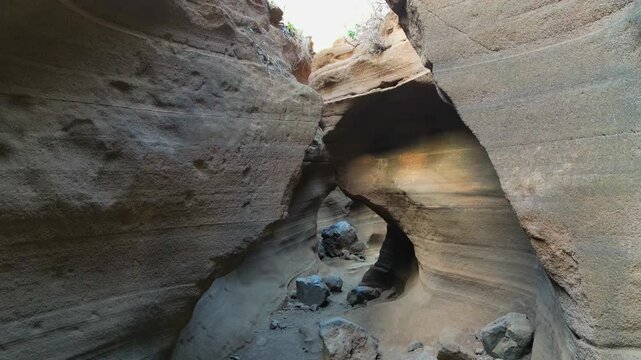 Smooth and eroded sandstone walls inside the narrow Barranco de las Vacas in Gran Canaria