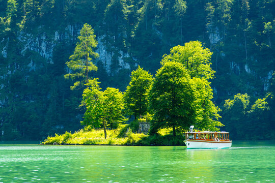 Konigssee Lake, Boat, Steep Mountain Slope and Christlieger Island. Bavaria, Germany