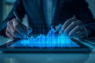Businessperson analyzing digital financial growth data on tablet.