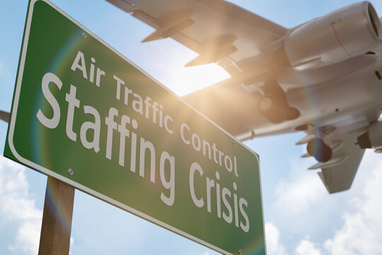 Air Traffic Control Staffing Crisis Green Road Sign with Airplane Above.