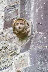 Carved stone head and face on the ruins of St. David's Cathedral.