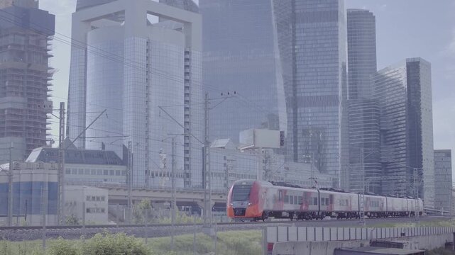 Electric train moving by Moscow City skyscrapers, D-Log footage