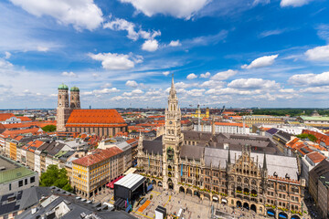 Fototapeta premium New Town Hall and Frauenkirche Church on Sunny Summer Day. Tourists on Marienplatz. Munich Skyline Panorama. Old Town. Bavaria, Germany. View from Tower of Alter Peter. Wide Shot