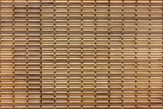 Geometric glass wall pattern in the Prague metro station with reflective golden and brown tones creating a modern design.