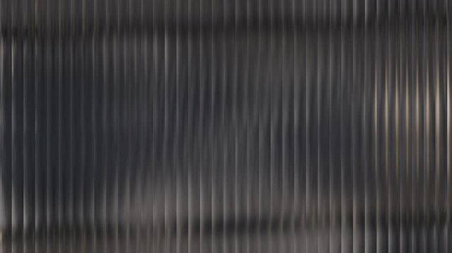 Dark textured surface with vertical ridges and subtle reflections creating a modern abstract background.
