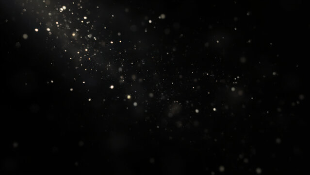 Abstract background of sparkling glitter particles floating in the dark