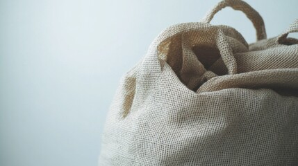 A tan bag with a white handle. The bag is open and has a white interior